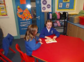 Our P5 Reading Stories to our P3 for World Book Day